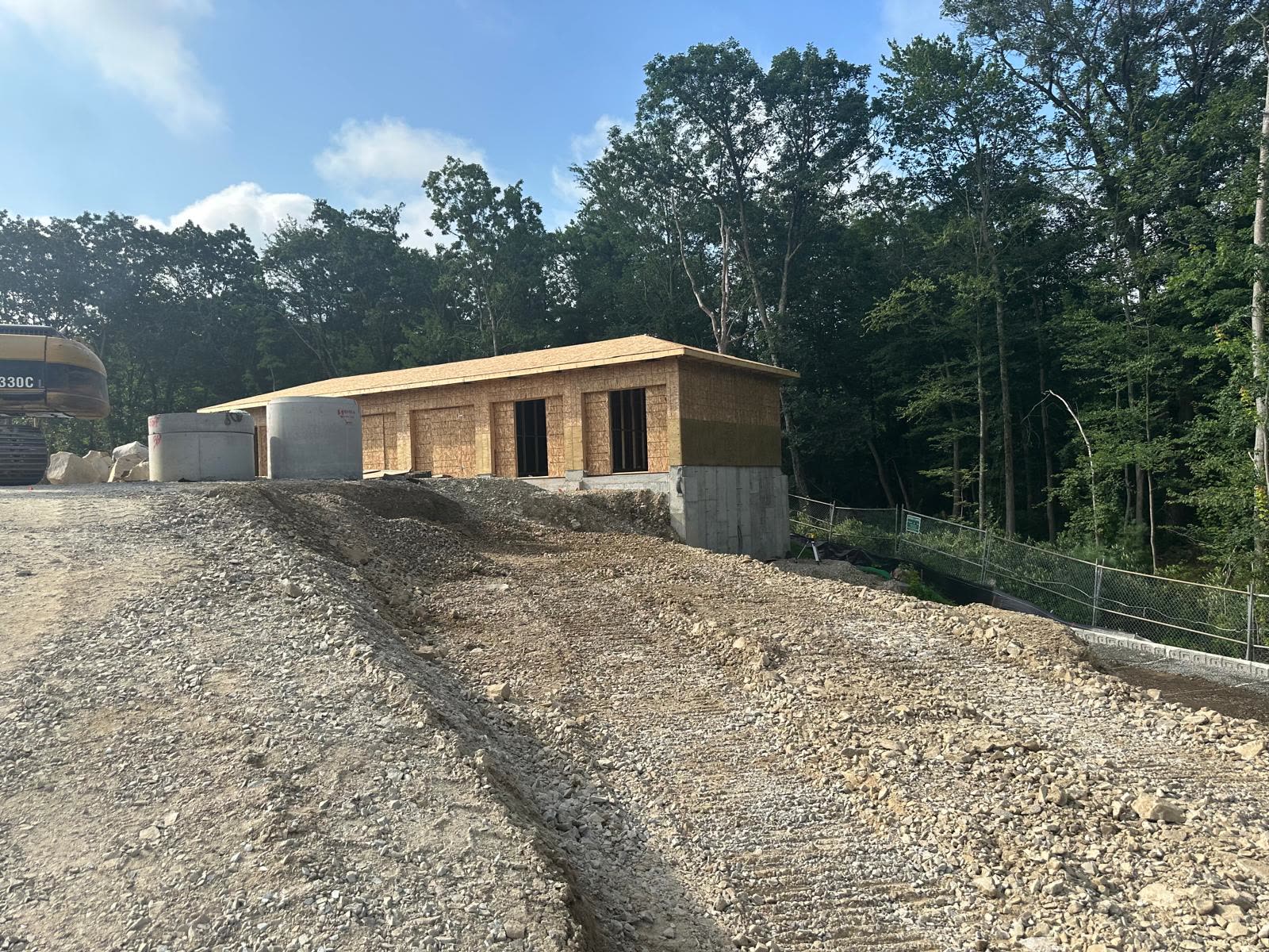 OSB-sheathed garage building on a hillside jobsite